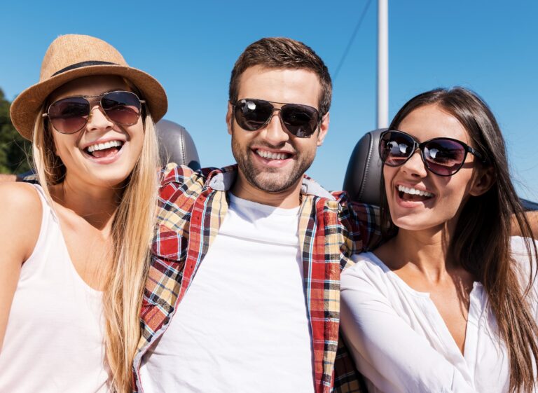 man with two women in sunshine