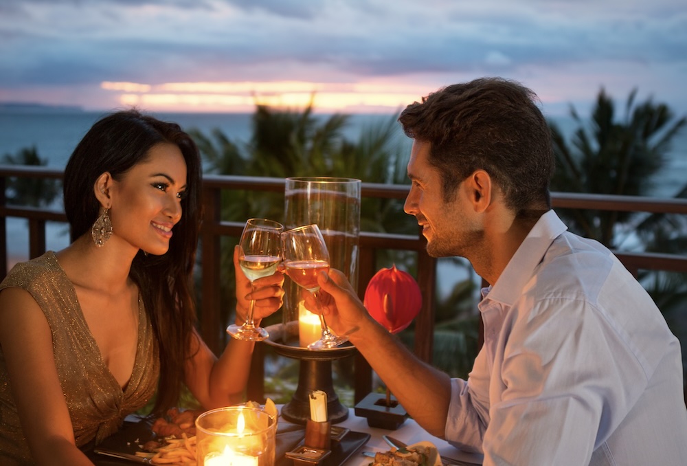 swinger terms feature image showing a couple on a date with an ocean view