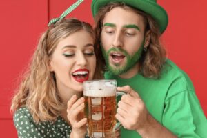 couple in green sharing beer presumably on St Patricks day