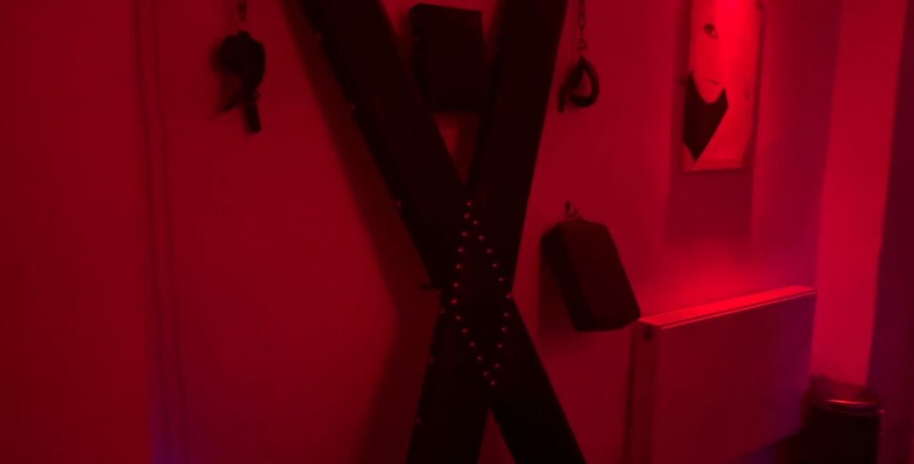Dungeon at Le Boudoir Club in London, St.Andrews Cross visible and playroom equipments