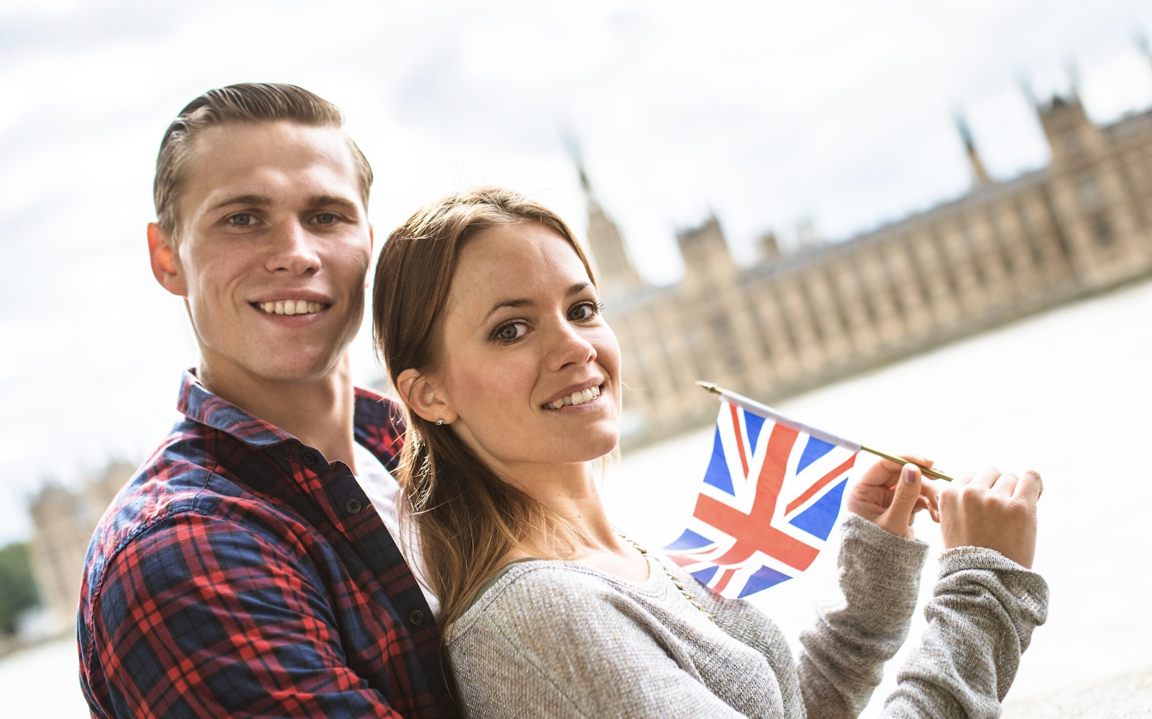 london couple holding UK flag in front of big ben