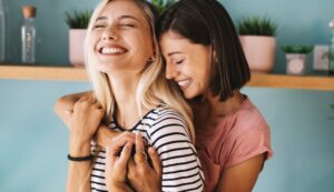 women partners joyfully embracing