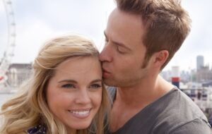 Guy kissing girl's head in london